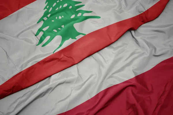 Waving colorful flag of poland and national flag of lebanon. — Stock Photo, Image