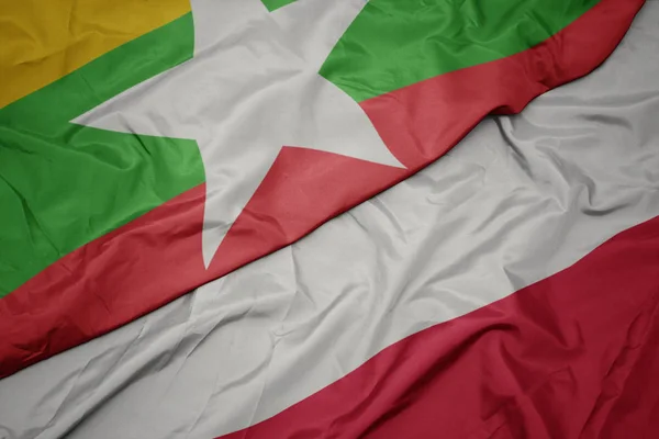 Schwenken bunte Flagge von Polen und Nationalflagge von Myanmar. — Stockfoto