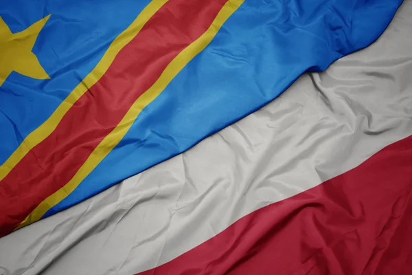 Viftande färgglada flagga poland och nationell flagga av . — Stockfoto