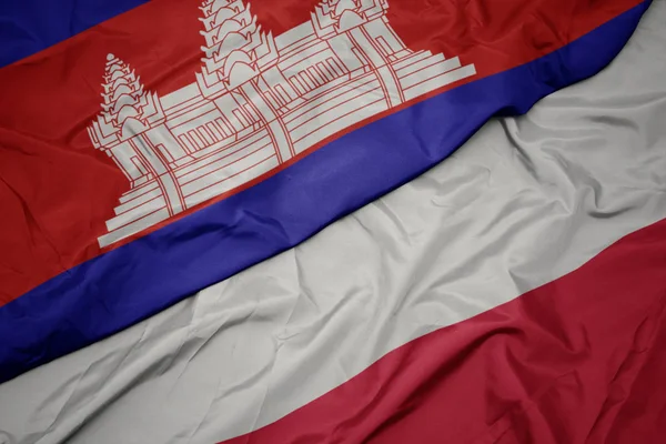 Acenando bandeira colorida de polônia e bandeira nacional de cambodia . — Fotografia de Stock