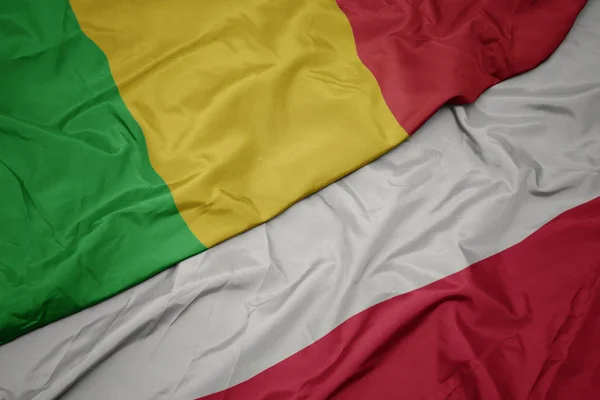 Waving colorful flag of poland and national flag of mali. — Stock Photo, Image