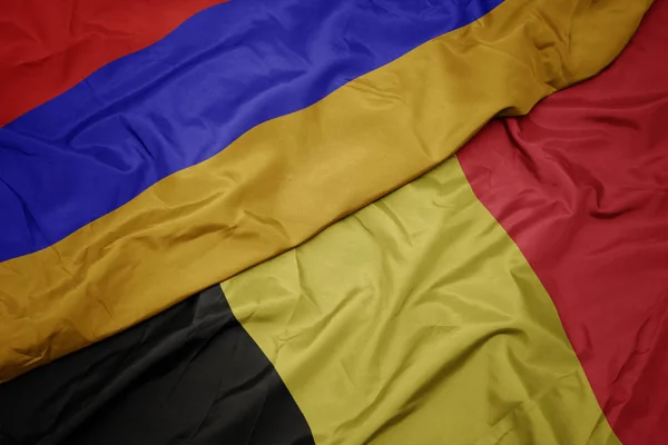 Acenando bandeira colorida da Bélgica e bandeira nacional da Arménia . — Fotografia de Stock