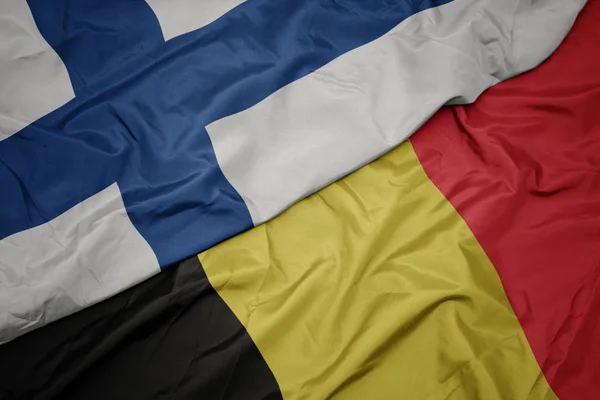 Zwaaiende vlag van België en nationale vlag van Finland. — Stockfoto