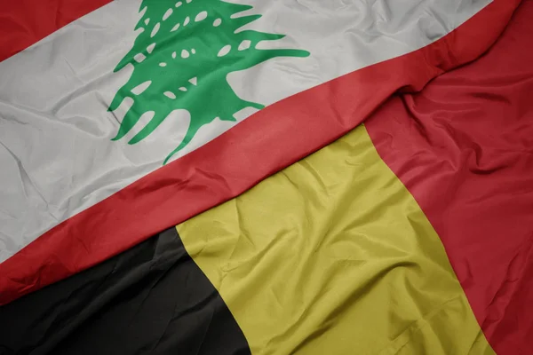 Sventolando bandiera colorata del belgio e bandiera nazionale del libanone . — Foto Stock