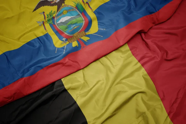 Ondeando colorida bandera de belgium y bandera nacional de ecuador . —  Fotos de Stock
