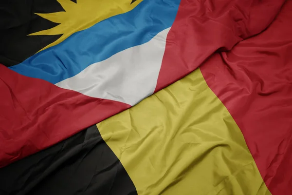 Waving colorful flag of belgium and national flag of antigua and barbuda. — Stock Photo, Image