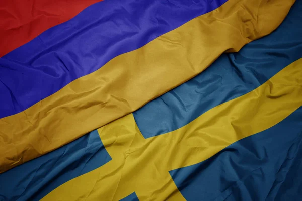 Sventolando bandiera colorata della Svezia e bandiera nazionale di armenia . — Foto Stock