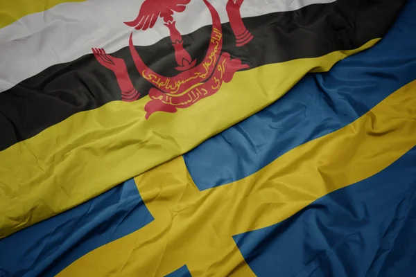 Waving colorful flag of sweden and national flag of brunei. — Stock Photo, Image
