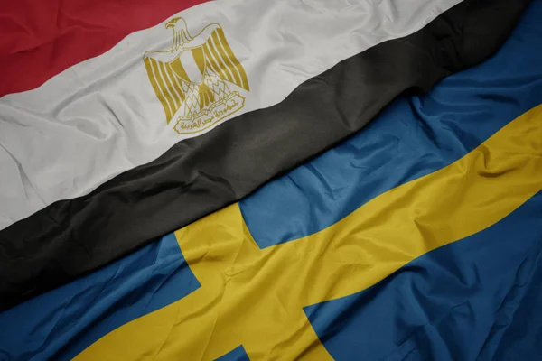 Zwaaiende vlag van Zweden en nationale vlag van Egypte . — Stockfoto