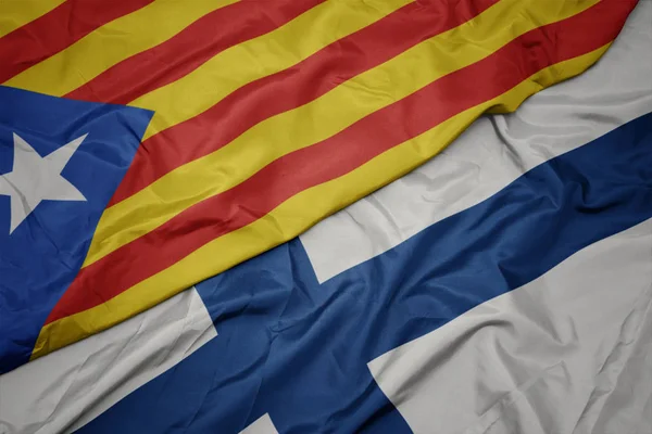 Waving colorful flag of finland and national flag of catalonia. — Stock Photo, Image