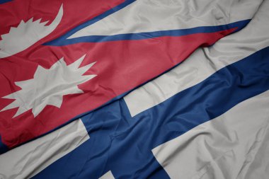 Finlandiya 'nın renkli bayrağı ve Nepal' in ulusal bayrağı sallanıyor..