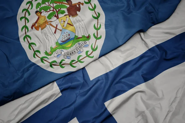 Waving colorful flag of finland and national flag of belize. — Stock Photo, Image