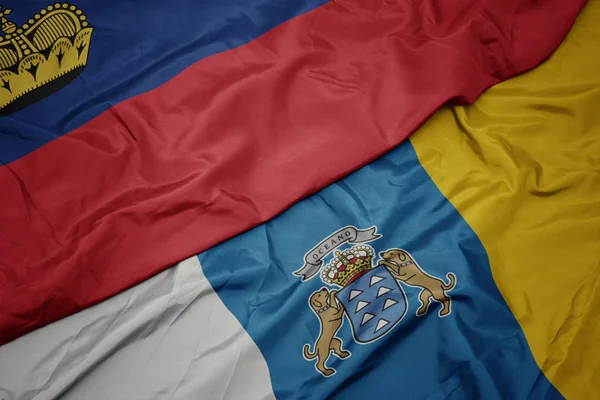 Ondeando colorida bandera de las islas canarias y la bandera nacional de liechtenstein . —  Fotos de Stock