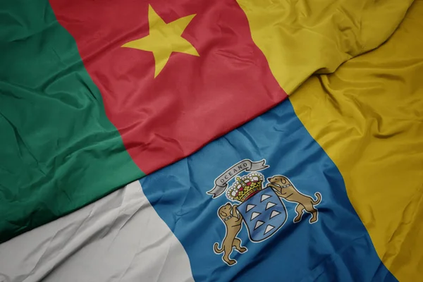 Ondeando colorida bandera de las islas canarias y bandera nacional de camerún . — Foto de Stock