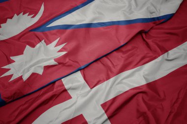 Danimarka 'nın renkli bayrağı ve Nepal' in ulusal bayrağı sallanıyor..