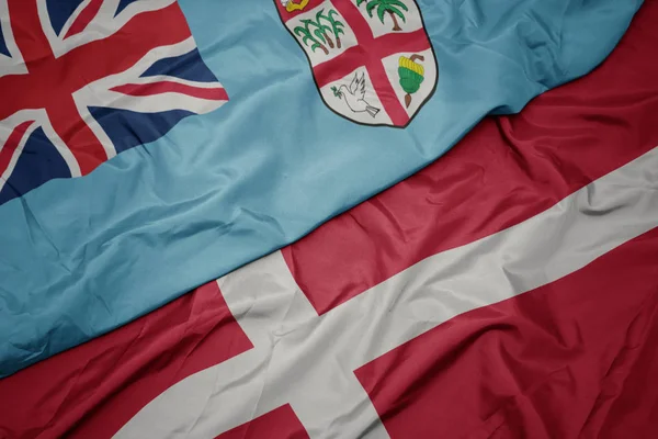 Waving colorful flag of denmark and national flag of Fiji . — Stock Photo, Image