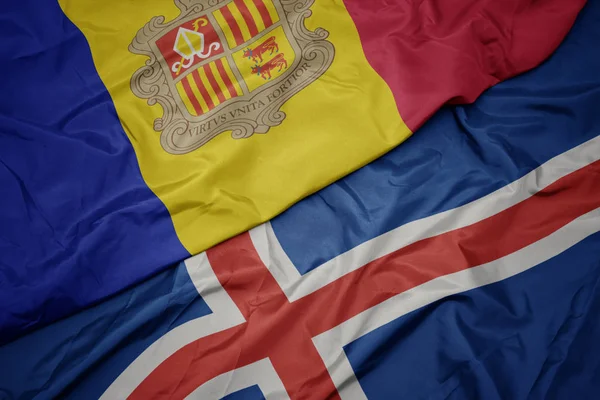 İzlanda 'nın renkli bayrağını sallıyor ve Andorra' nın ulusal bayrağını sallıyor.. — Stok fotoğraf