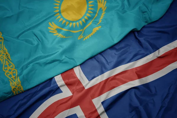 İzlanda 'nın renkli bayrağı ve Kazakistan' ın ulusal bayrağı sallanıyor.. — Stok fotoğraf
