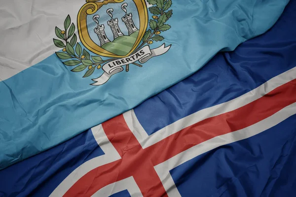 Κυματίζει πολύχρωμη σημαία της iceland και την εθνική σημαία του Σαν Μαρίνο. — Φωτογραφία Αρχείου