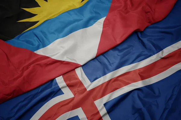 Waving colorful flag of iceland and national flag of antigua and barbuda. — Zdjęcie stockowe
