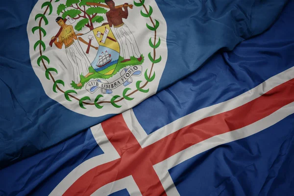 Waving colorful flag of iceland and national flag of belize. — Stock Photo, Image