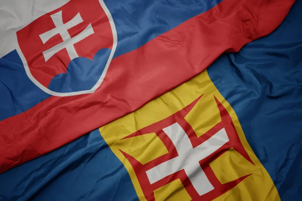 Acenando bandeira colorida da madeira e bandeira nacional da eslováquia . — Fotografia de Stock