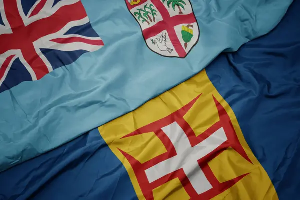 Waving colorful flag of madeira and national flag of Fiji . — Stock Photo, Image