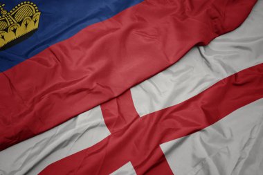 waving colorful flag of england and national flag of liechtenstein.