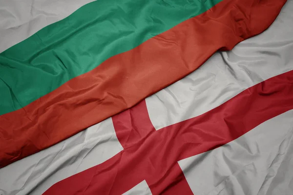 Waving colorful flag of england and national flag of bulgaria. — ストック写真