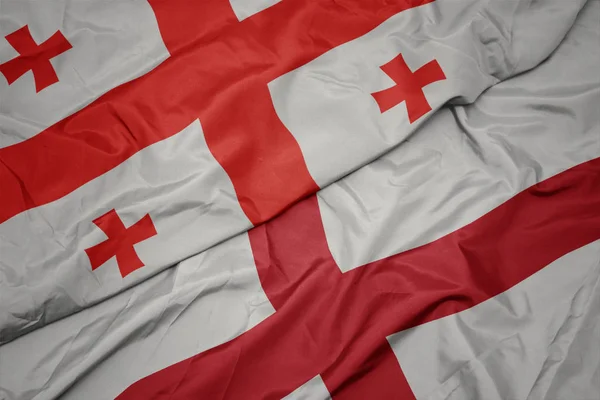 Waving colorful flag of england and national flag of georgia. — Stock Photo, Image