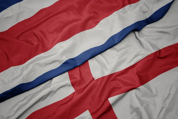 waving colorful flag of england and national flag of costa rica.