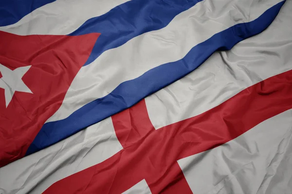 Ondeando colorida bandera de Inglaterra y bandera nacional de Cuba . —  Fotos de Stock