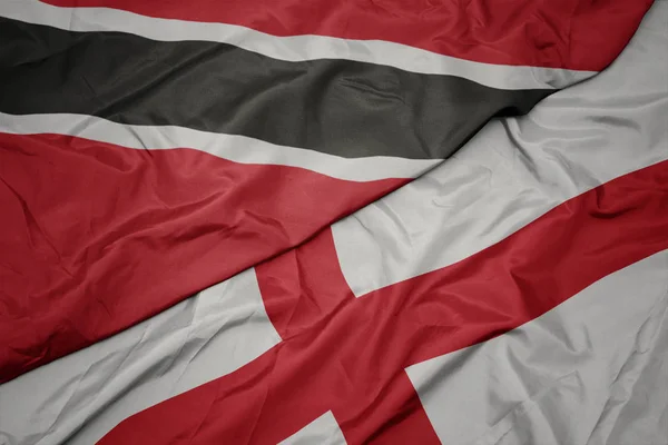 Waving colorful flag of england and national flag of trinidad and tobago. — Stock Photo, Image