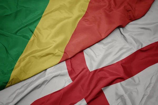 waving colorful flag of england and national flag of republic of the congo.