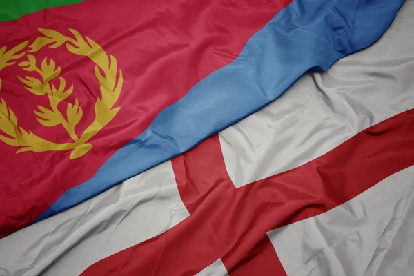 waving colorful flag of england and national flag of eritrea.