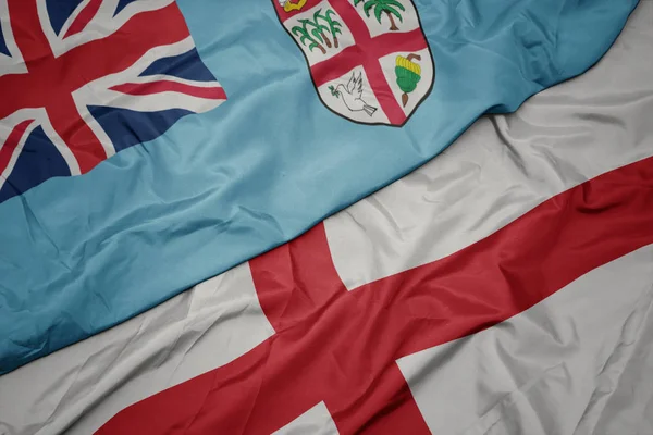 Waving colorful flag of england and national flag of Fiji . — Stock Photo, Image