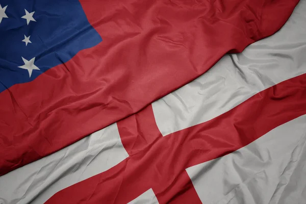 waving colorful flag of england and national flag of Samoa .