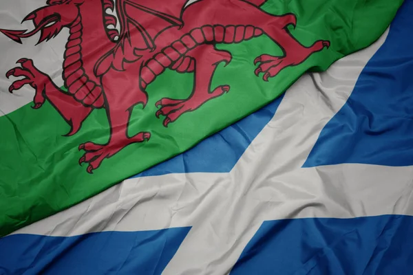 waving colorful flag of scotland and national flag of wales.
