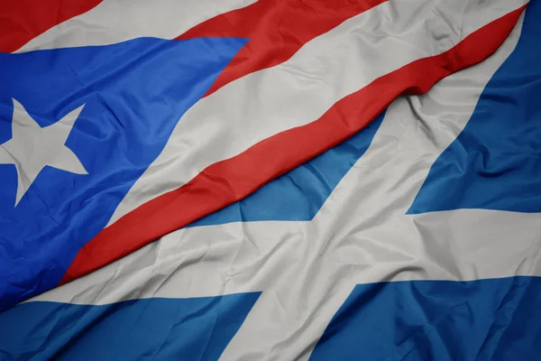 waving colorful flag of scotland and national flag of puerto rico.