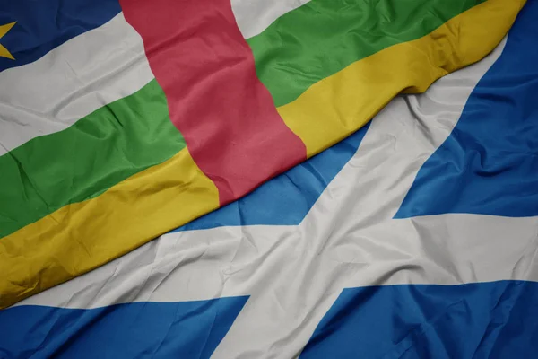 waving colorful flag of scotland and national flag of central african republic.