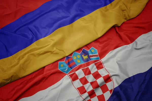 Mávání barevnou vlajkou Chorvatska a národní vlajky Arménie. — Stock fotografie
