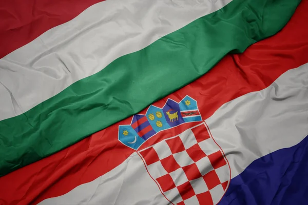 Ondeando colorida bandera de croacia y bandera nacional de hungary . —  Fotos de Stock