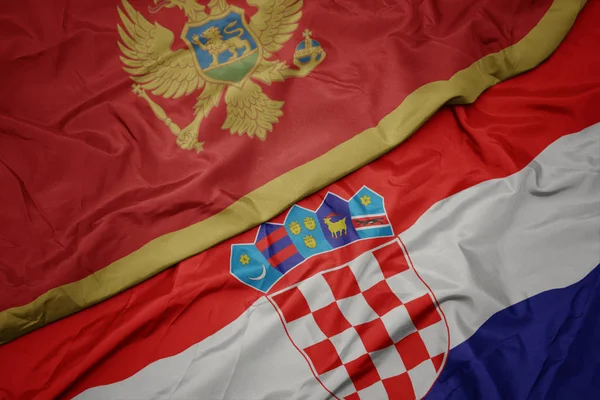 Mávání barevnou vlajkou Chorvatska a národní vlajky Montenegro. — Stock fotografie