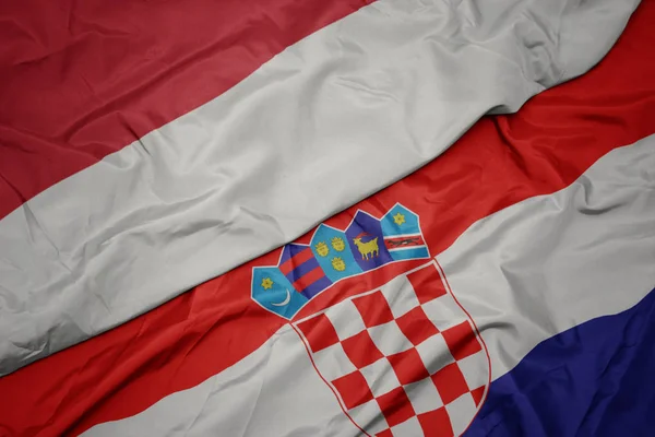 Ondeando colorida bandera de croacia y bandera nacional de indonesia . —  Fotos de Stock