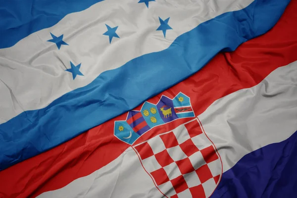 Ondeando colorida bandera de croacia y bandera nacional de honduras . —  Fotos de Stock