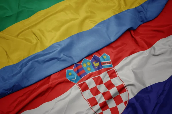 Waving colorful flag of croatia and national flag of gabon. — Stock Photo, Image