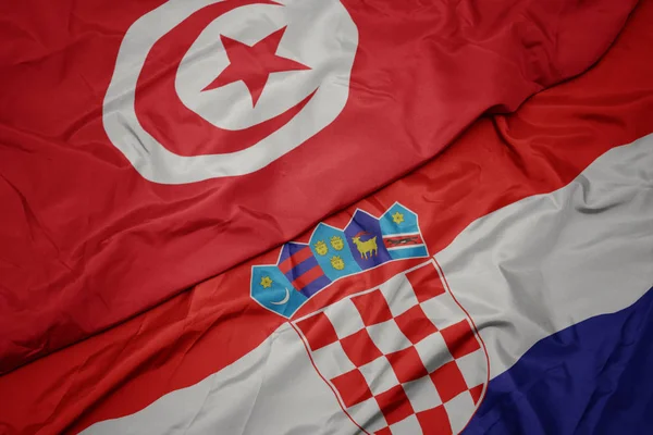 Waving colorful flag of croatia and national flag of tunisia. — Stock Photo, Image