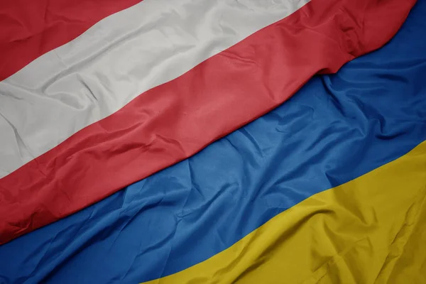 Waving colorful flag of ukraine and national flag of austria. — Stock Photo, Image