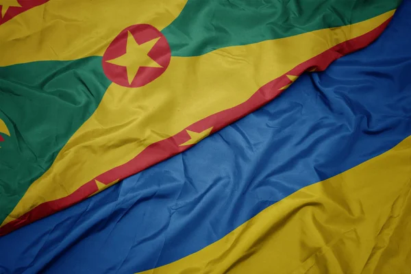 Waving colorful flag of ukraine and national flag of grenada. — Zdjęcie stockowe