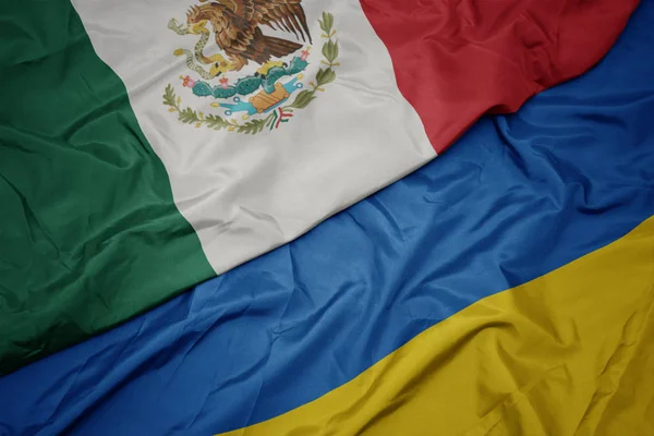 Waving colorful flag of ukraine and national flag of mexico. — Stock Photo, Image
